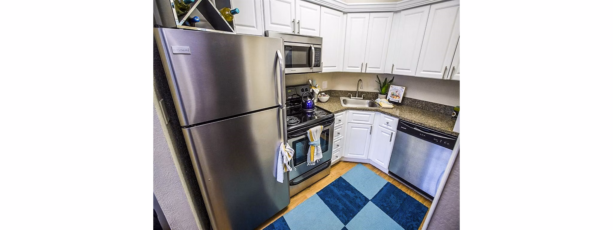 Modern kitchen with stainless steel appliances at The Laurels Apartments