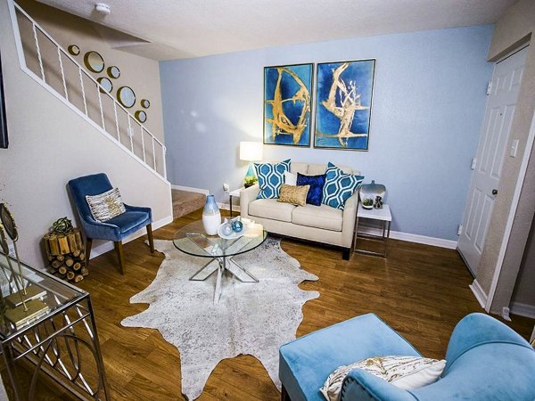 Spacious living room with modern decor at The Laurels Apartments in luxury Greystar community