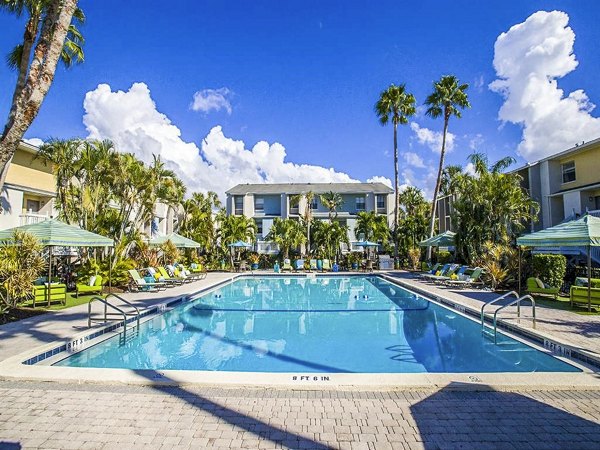 Resort-style outdoor pool with sun loungers at The Laurels Apartments