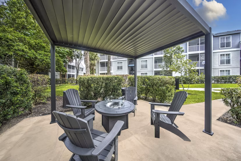 Charming patio with cozy seating at Avana Coral Springs Apartments, ideal for relaxation in luxury surroundings