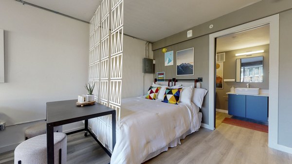 Bedroom featuring modern decor and ample natural light at River Roost Apartments