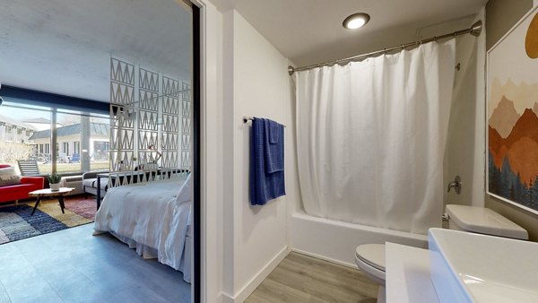 Modern bathroom with sleek fixtures and double vanity at River Roost Apartments, luxury living by the river