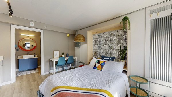 Cozy bedroom with modern furnishings at River Roost Apartments, offering luxury living in a serene setting