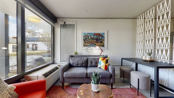 Inviting living room with stylish decor and natural light at River Roost Apartments