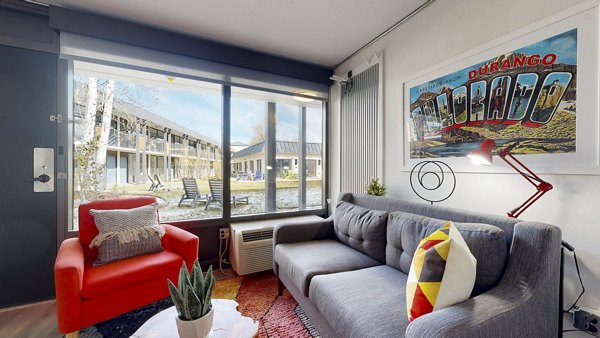 Spacious living room with modern furnishings at River Roost Apartments, offering comfort and style in luxury living