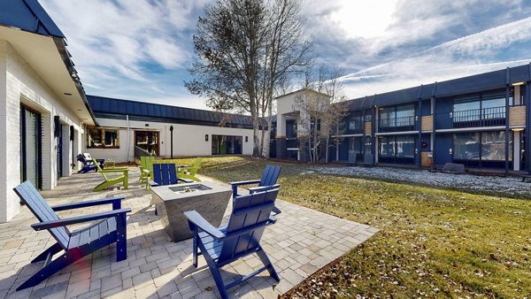 Fire pit area with outdoor seating at River Roost Apartments, offering a cozy ambiance for residents to enjoy in the evenings