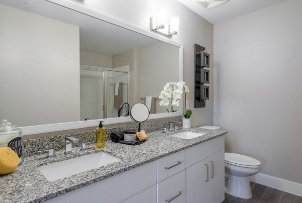 Spa-like bathroom featuring marble countertops and modern fixtures in The Palms at Cape Coral Apartments