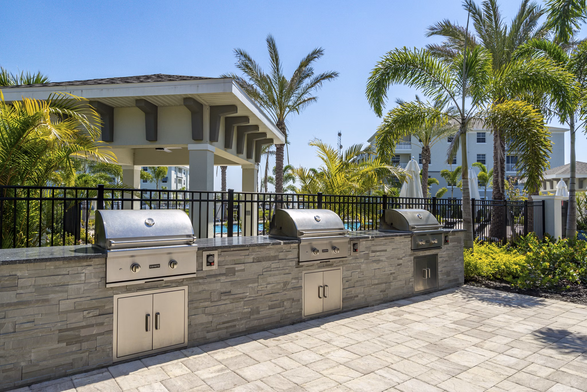 Outdoor grill area with modern appliances at The Palms at Cape Coral Apartments, perfect for hosting gatherings and enjoying the Florida weather
