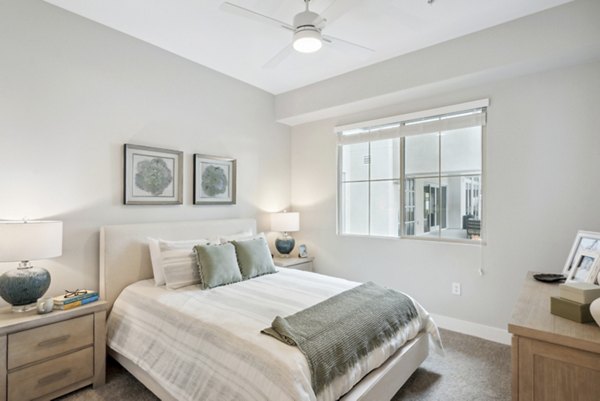 Cozy bedroom with large windows and modern decor at Overture North Scottsdale Apartments