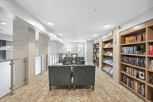 Clubhouse library featuring cozy seating and extensive book collection at Overture North Scottsdale luxury apartments