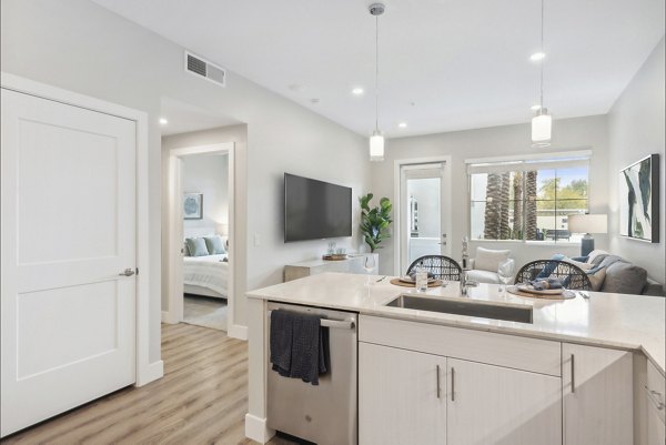 Contemporary kitchen featuring stainless steel appliances and granite countertops in Overture North Scottsdale Apartments