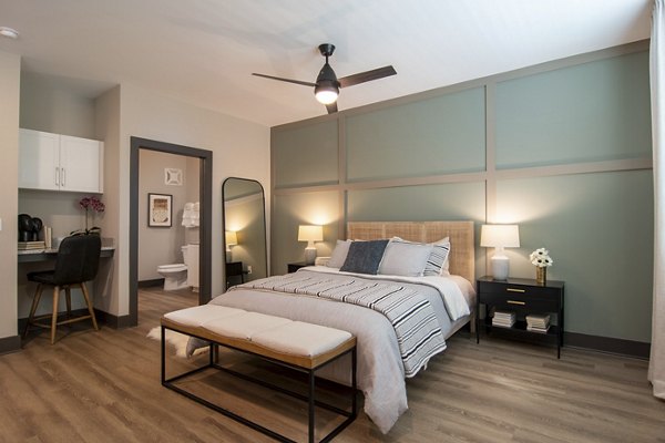 Modern bedroom with stylish decor at The Foundry at Mashburn Village Apartments