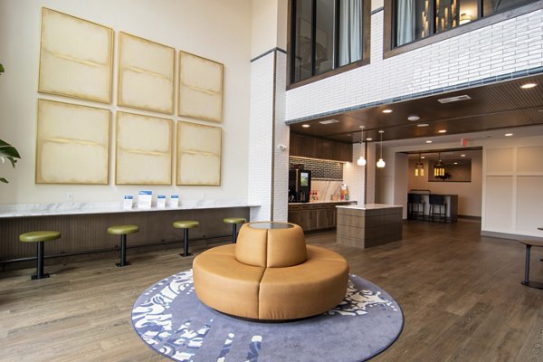 Clubhouse with modern furnishings at The Foundry at Mashburn Village Apartments