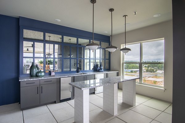 Clubhouse featuring modern seating and entertainment areas at The Foundry at Mashburn Village Apartments