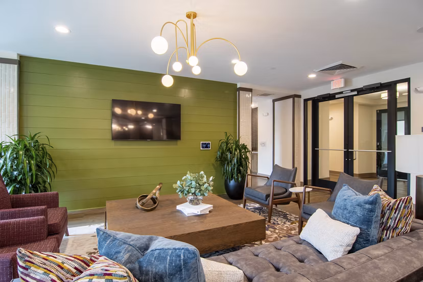 Stylish clubhouse at The Foundry at Mashburn Village Apartments with cozy seating and modern decor