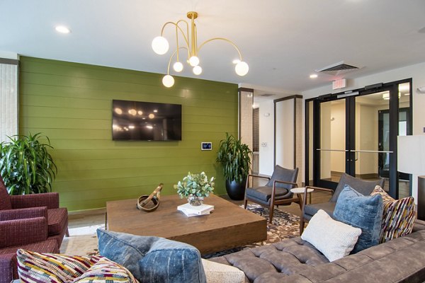 Stylish clubhouse at The Foundry at Mashburn Village Apartments with cozy seating and modern decor