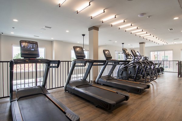 State-of-the-art fitness center at The Foundry at Mashburn Village Apartments with modern equipment and spacious workout areas