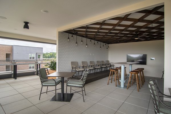 Modern outdoor patio with cozy seating and string lights at The Foundry at Mashburn Village Apartments