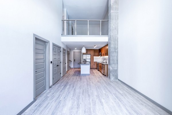 Living room with modern furniture and large windows at Marlow Apartments