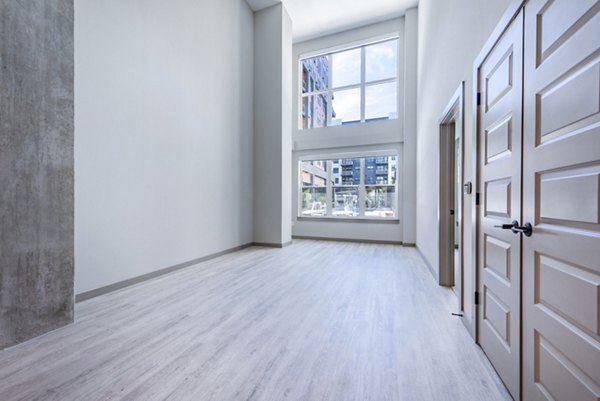 Spacious living room with modern decor and ample natural light in Marlow Apartments
