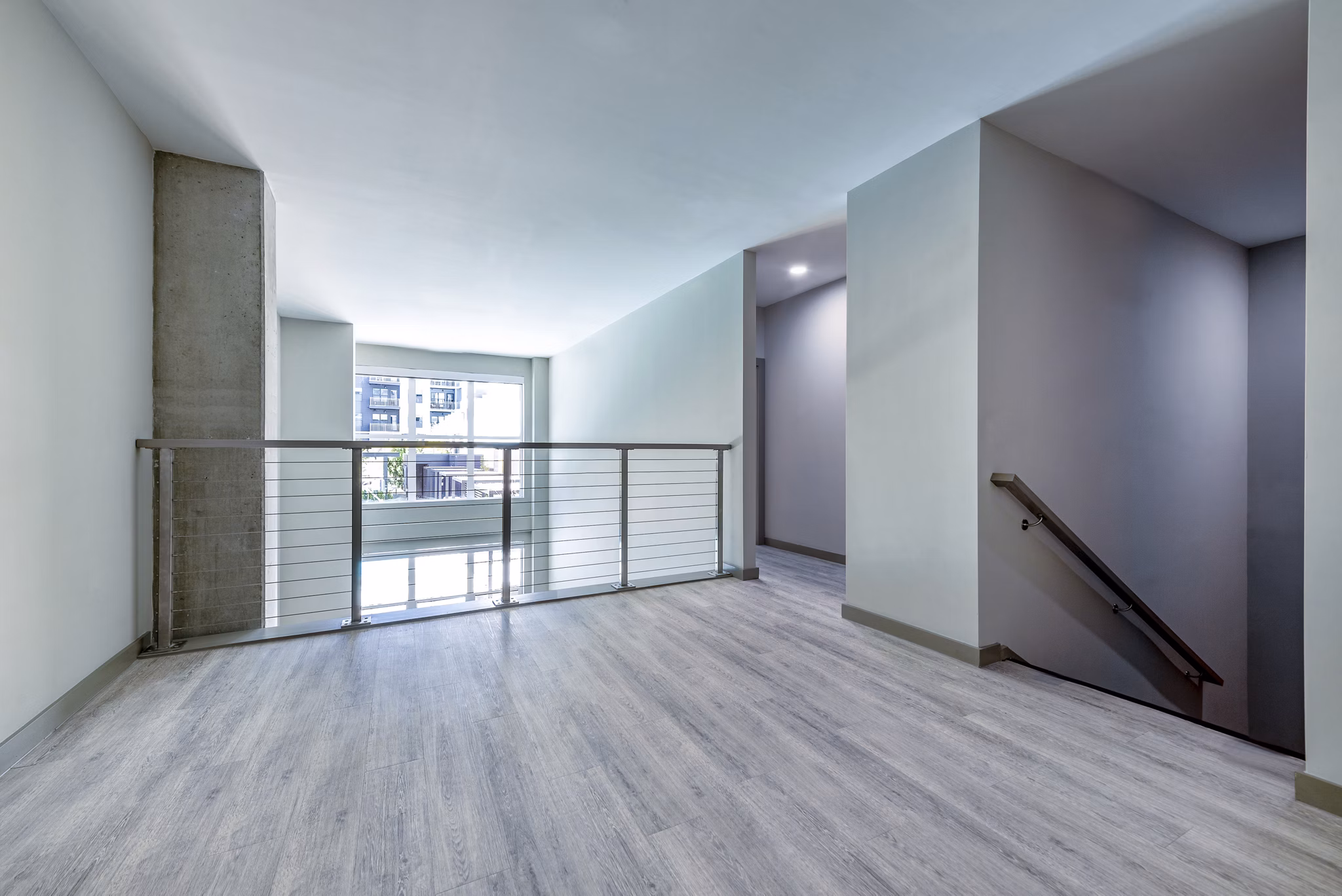 Upstairs home office with cozy living area in Marlow Apartments, ideal for remote work and relaxation