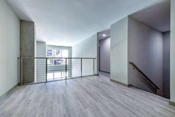 Upstairs home office with cozy living area in Marlow Apartments, ideal for remote work and relaxation