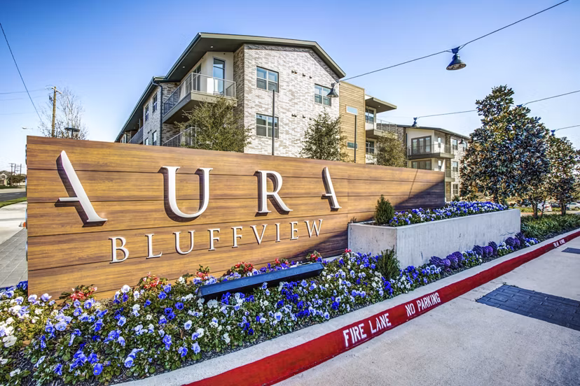 Signage displaying Bluffs at Midway Hollow luxury apartments entrance