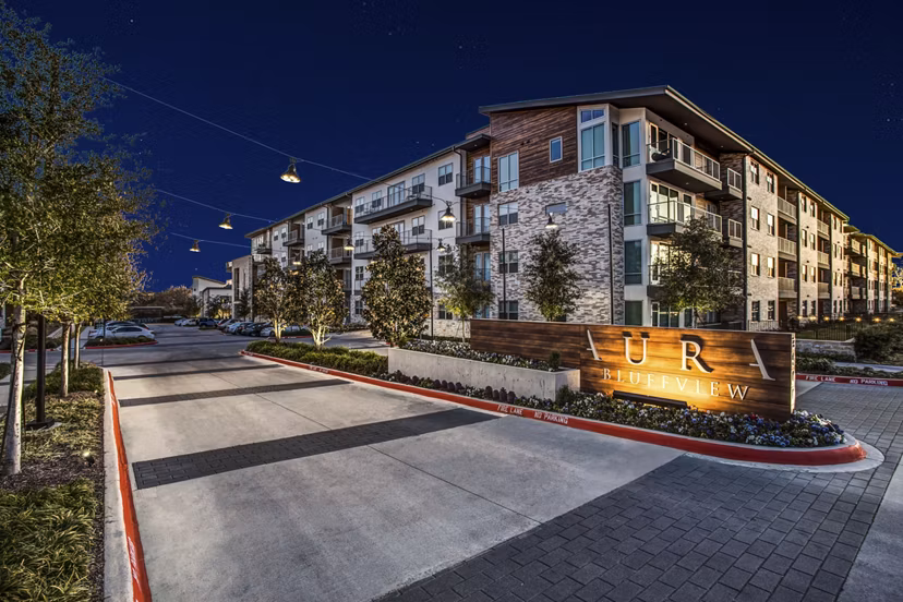 UR RIVERVIEW: Elegant luxury apartment complex illuminated at night