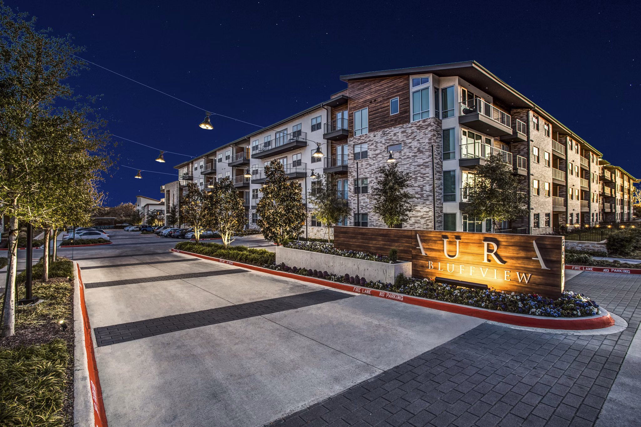 UR RIVERVIEW: Elegant luxury apartment complex illuminated at night