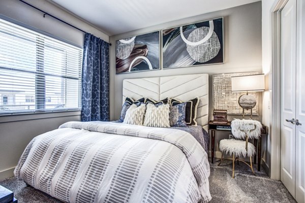 Spacious bedroom with modern furnishings in Bluffs at Midway Hollow Apartments