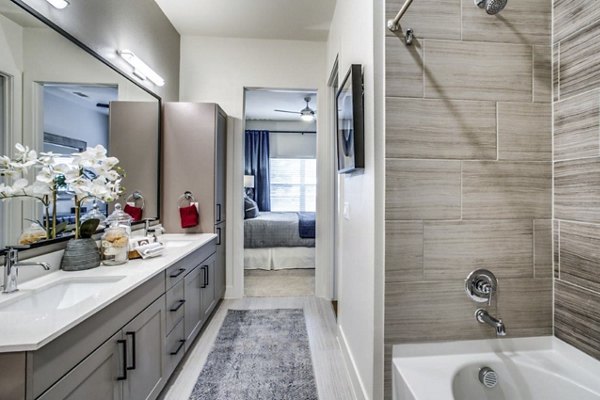 Modern bathroom with marble countertops and spacious shower at Bluffs at Midway Hollow Apartments