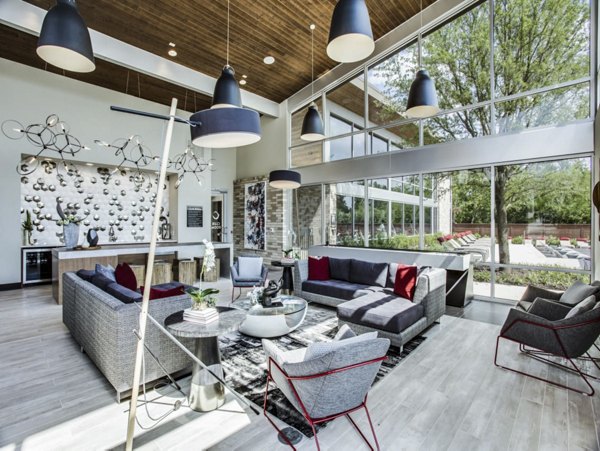 Modern clubhouse with lounge and game areas at Bluffs at Midway Hollow Apartments