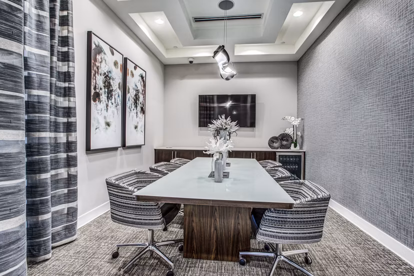 Contemporary clubhouse with cozy seating and high ceilings at Bluffs at Midway Hollow Apartments in Dallas
