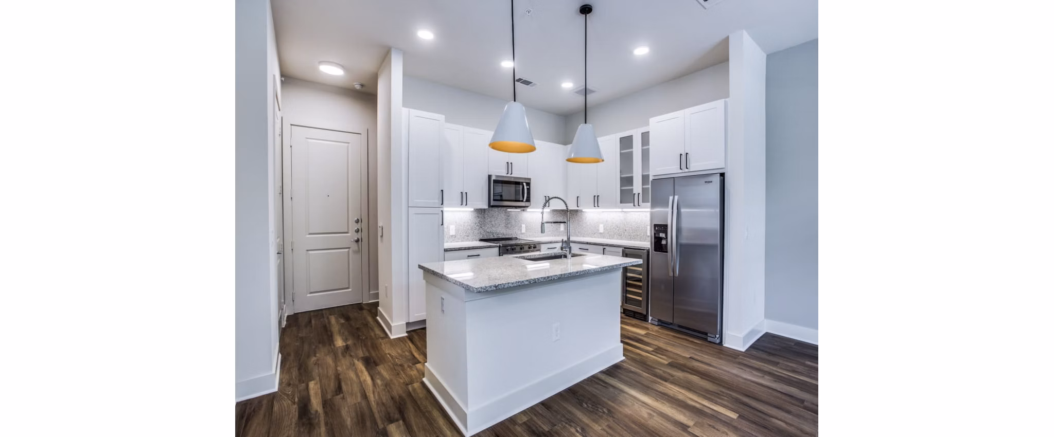 Contemporary kitchen with stainless steel appliances in Bluffs at Midway Hollow Apartments Perfect blend of style and functionality in this Greystar community