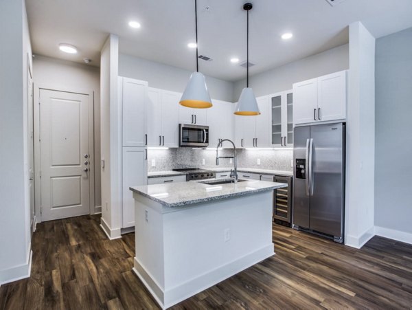 Contemporary kitchen with stainless steel appliances in Bluffs at Midway Hollow Apartments Perfect blend of style and functionality in this Greystar community