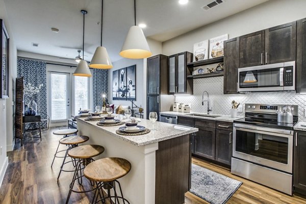 Modern kitchen with stainless steel appliances at Bluffs at Midway Hollow Apartments