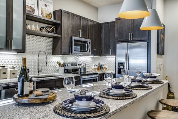 Modern kitchen with stainless steel appliances at Bluffs at Midway Hollow Apartments