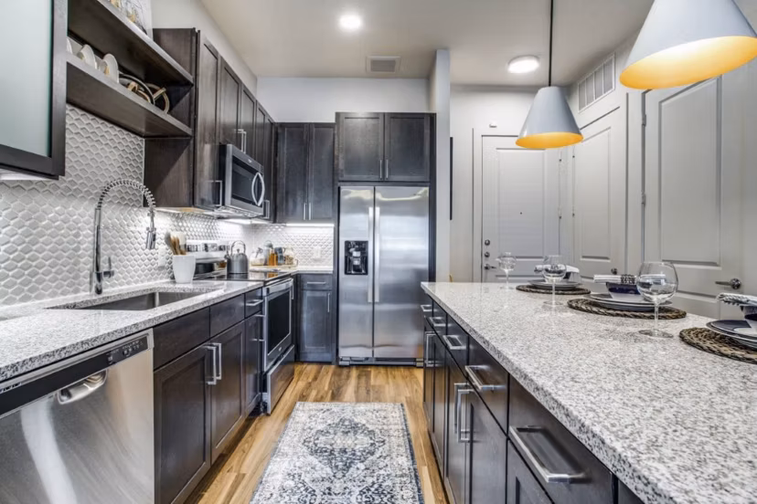 Modern kitchen with stainless steel appliances at Bluffs at Midway Hollow Apartments