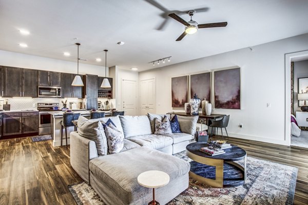 Modern living room with stylish decor and large windows in Bluffs at Midway Hollow Apartments