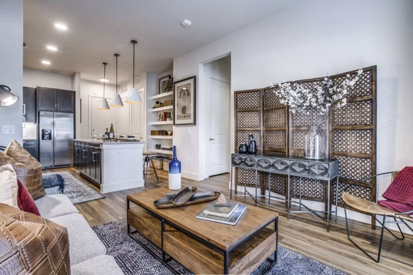 Modern living room with sleek furniture and natural light in Bluffs at Midway Hollow Apartments, a luxury Greystar property