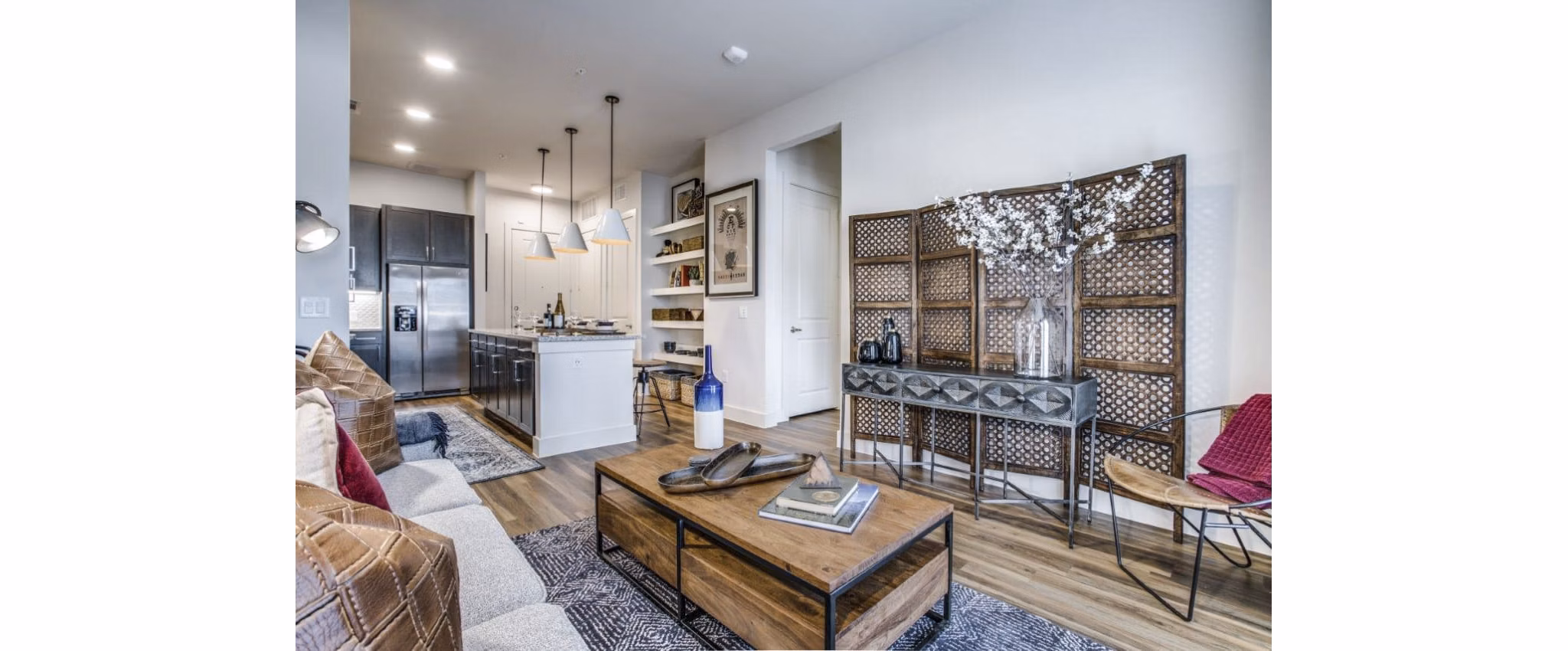 Modern living room with sleek furniture and natural light in Bluffs at Midway Hollow Apartments, a luxury Greystar property