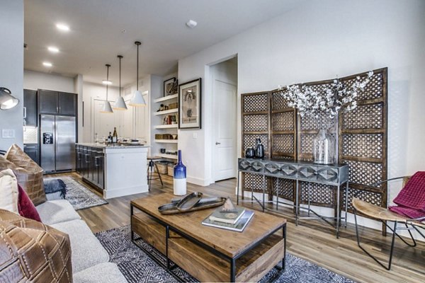 Modern living room with sleek furniture and natural light in Bluffs at Midway Hollow Apartments, a luxury Greystar property