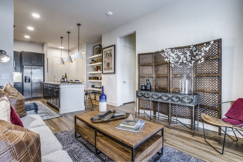 Modern living room with sleek furniture and natural light in Bluffs at Midway Hollow Apartments, a luxury Greystar property