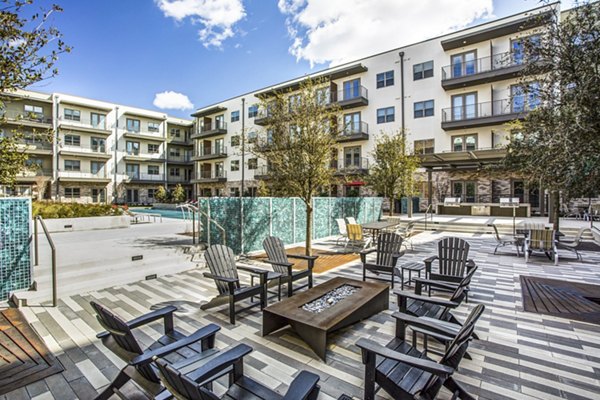 Bluffs at Midway Hollow: Welcoming fire pit patio for relaxation and community gatherings at luxury apartments in a serene setting
