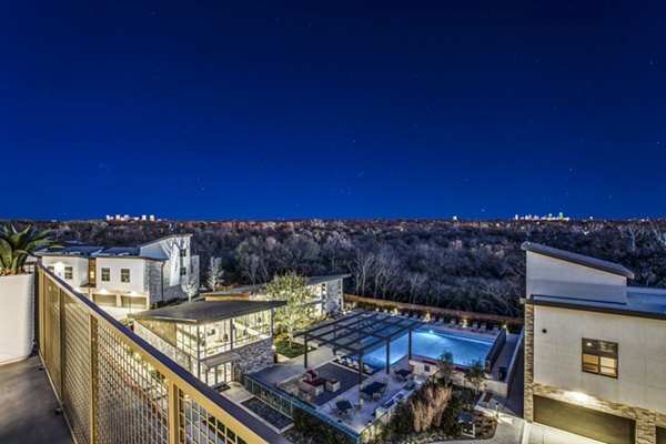 Patio with comfy seating and garden view at Bluffs at Midway Hollow Apartments