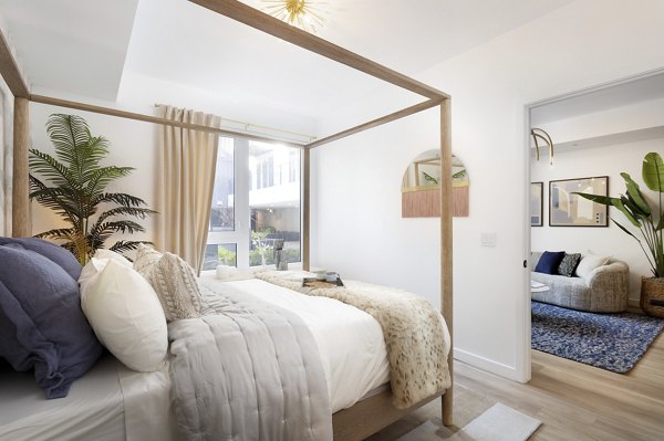 Elegant bedroom with modern decor at The Louise 4900 Apartments