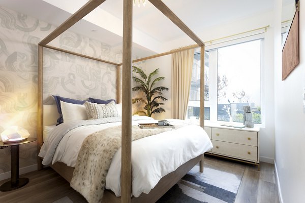 Bedroom featuring elegant decor and queen bed at The Louise 4900 Apartments