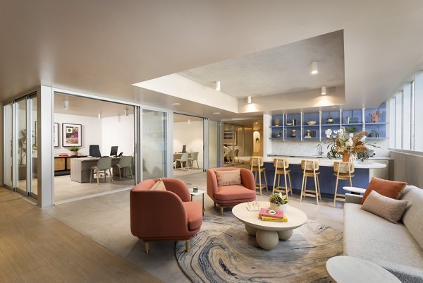 Clubhouse featuring modern design and seating areas at The Louise 4900 Apartments