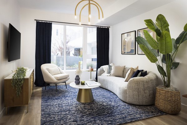 Spacious living room featuring modern dÃ©cor and natural light at The Louise 4900 Apartments