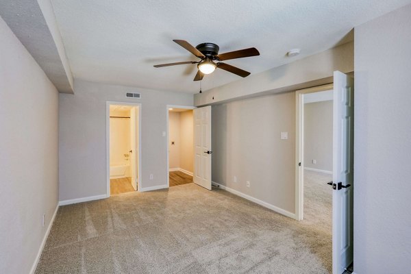 Cozy bedroom with modern decor and large window in The Lumiere Apartments, Metairie, LA
